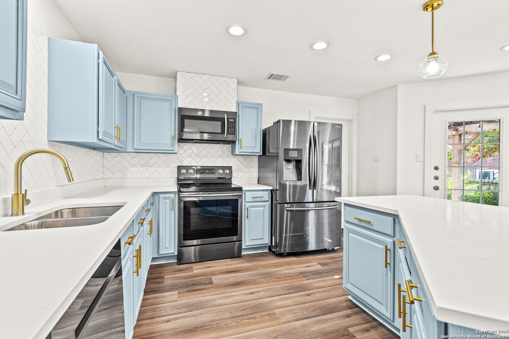 1687 Fir Circle Schertz, TX 78154 - Photo 8 of 25 a kitchen with stainless steel appliances a refrigerator stove and sink