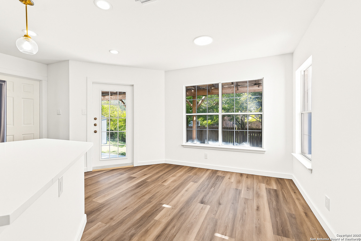 1687 Fir Circle Schertz, TX 78154 - Photo 10 of 25 a view of an empty room with wooden floor and a window