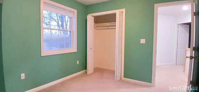 an empty room with windows and closet