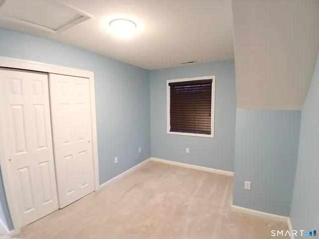 a large kitchen with stainless steel appliances a large counter top a stove a sink and a refrigerator