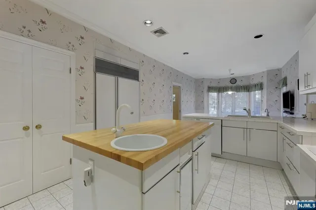 a kitchen with sink cabinets and stove