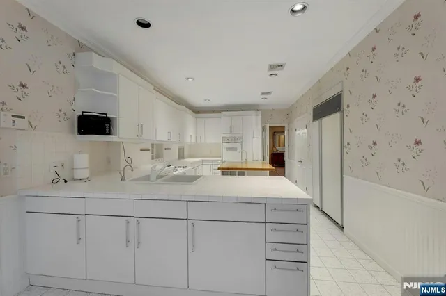 a bathroom with a double vanity sink a mirror and shower