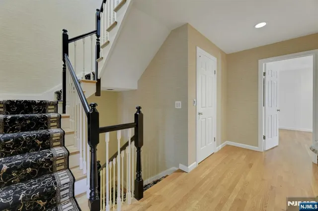 a view of entryway with wooden floor and stairs
