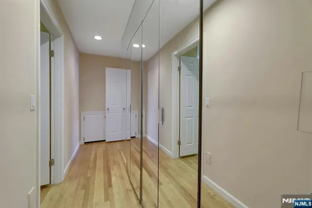 a view of hallway with wooden floor