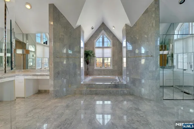 a bathroom with a glass shower door and a bathtub