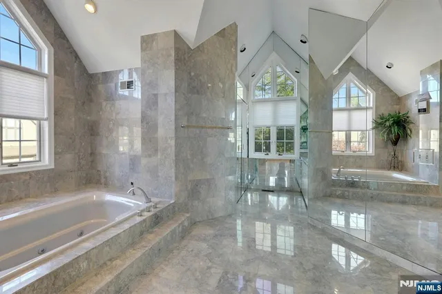 a bathroom with a bathtub and a shower