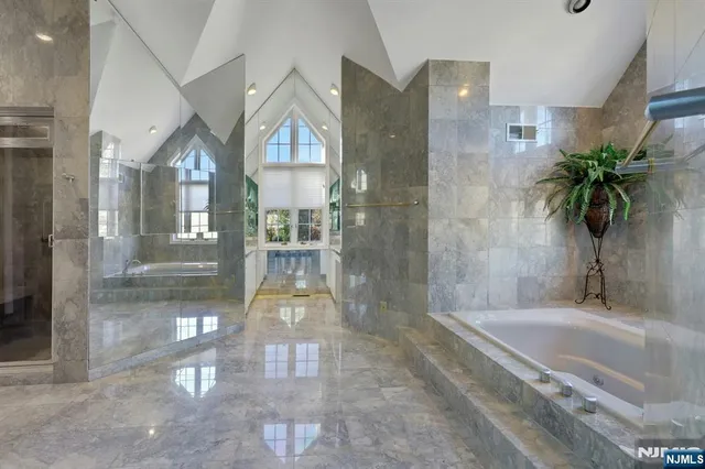 a bathroom with a glass shower door and a bathtub