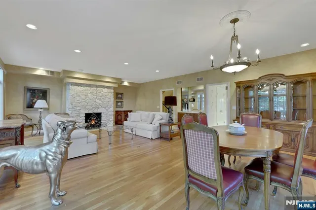 a living room with furniture a fireplace and a chandelier