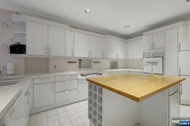 a kitchen with a stove sink and cabinets