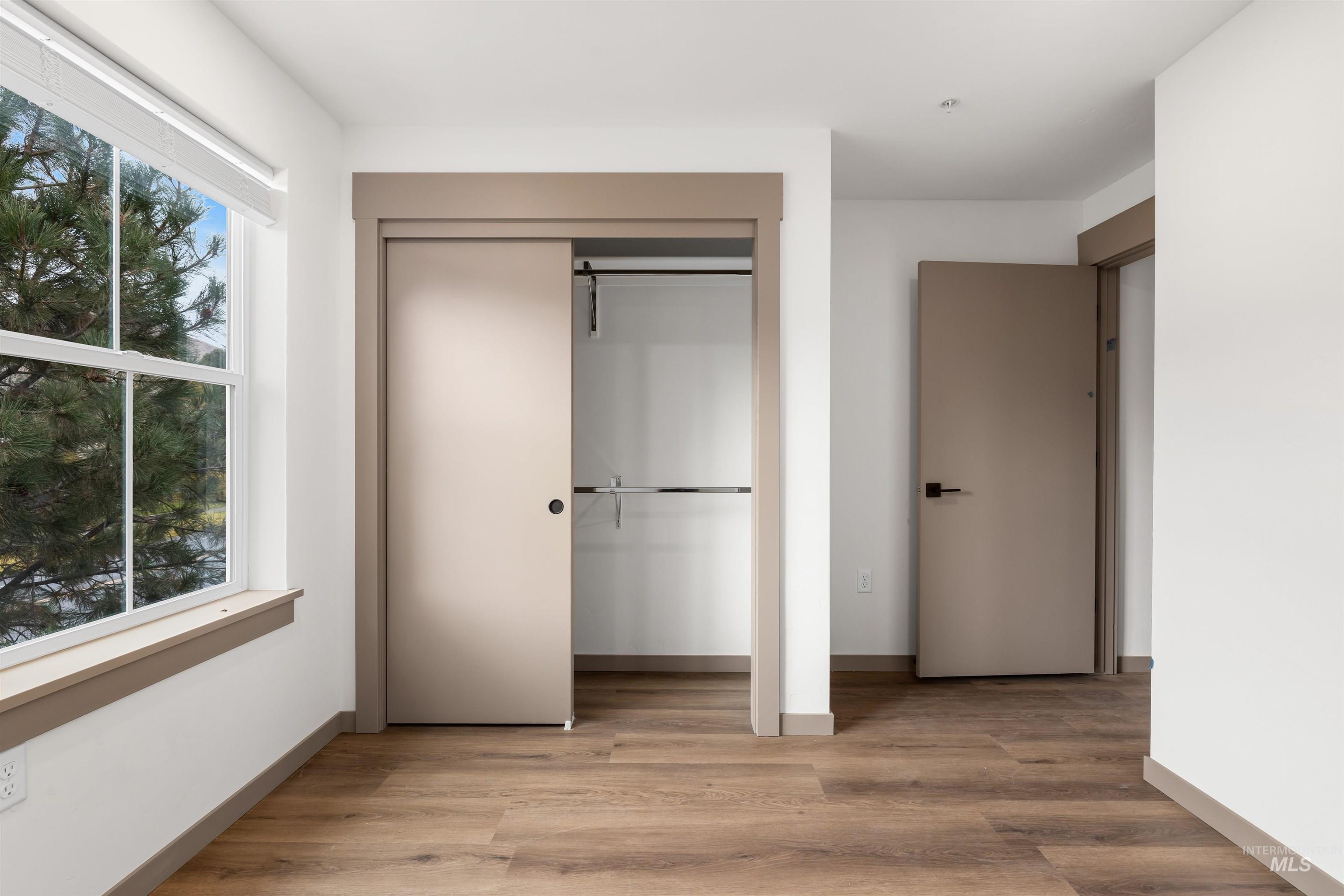 2010 Wimbledon Court Hailey, ID 83333 - Photo 16 of 46 Unfurnished bedroom featuring light wood-style floors, a closet, and multiple windows