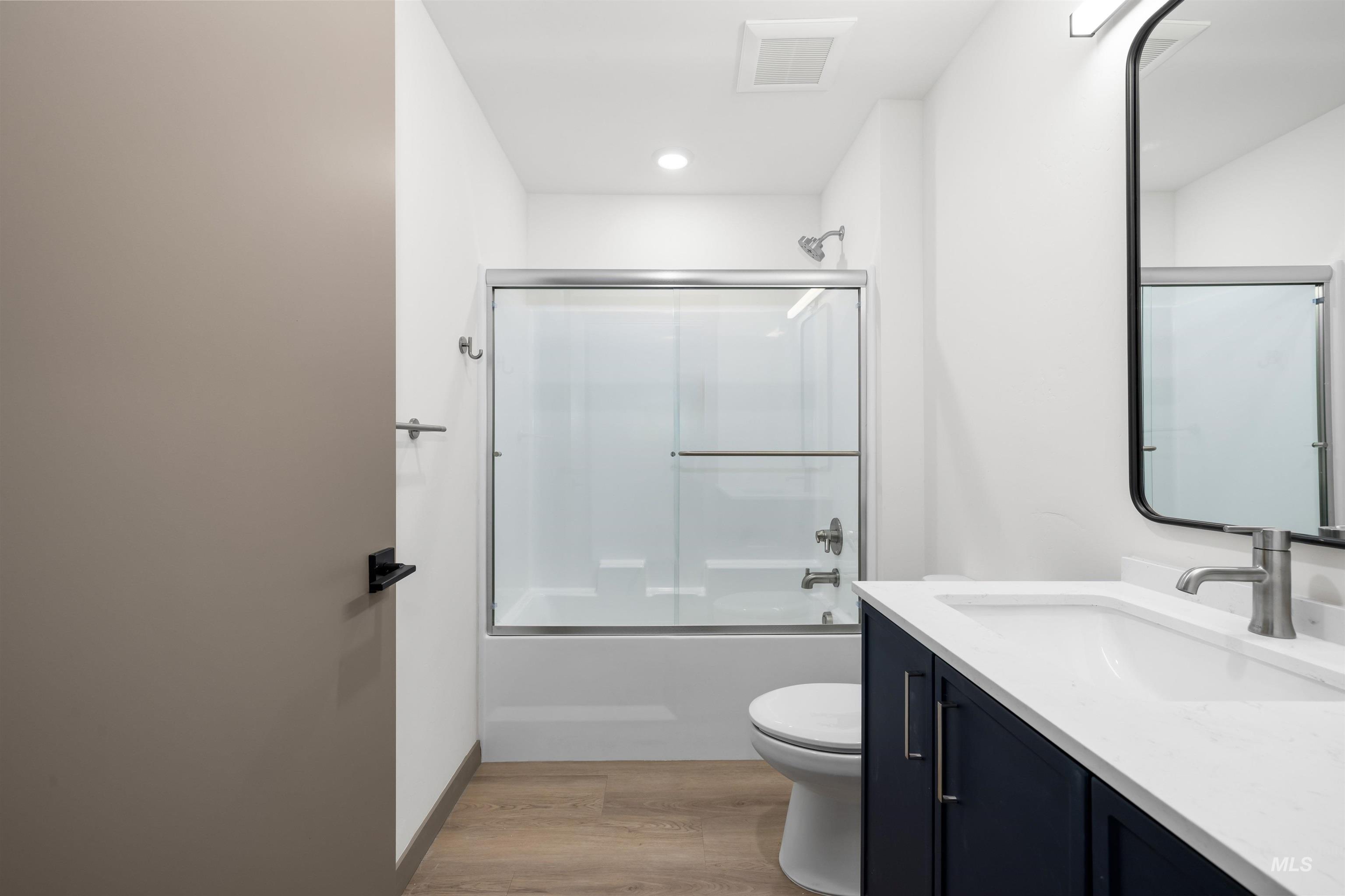 2010 Wimbledon Court Hailey, ID 83333 - Photo 22 of 46 Bathroom with vanity, shower / bath combination with glass door, and light wood-type flooring