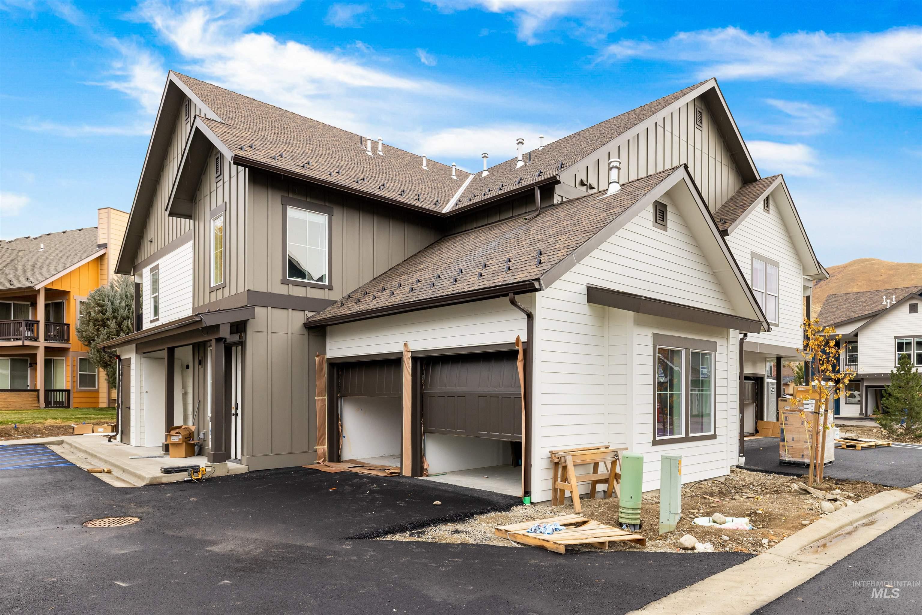 2010 Wimbledon Court Hailey, ID 83333 - Photo 28 of 46 View of home's exterior featuring board and batten siding, a shingled roof, asphalt driveway, and an attached garage