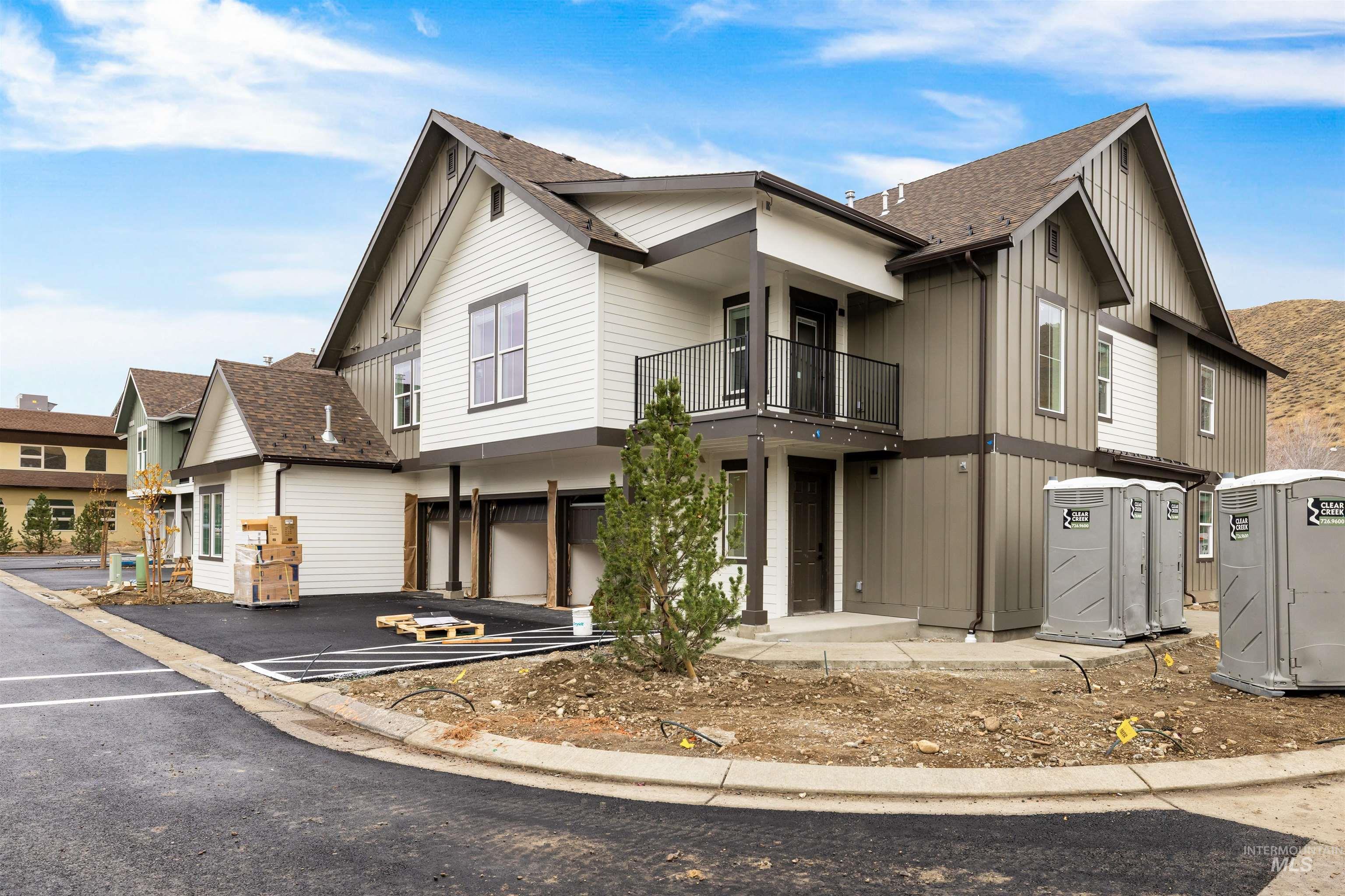 2010 Wimbledon Court Hailey, ID 83333 - Photo 3 of 46 View of front of house featuring a balcony, roof with shingles, board and batten siding, a garage, and driveway
