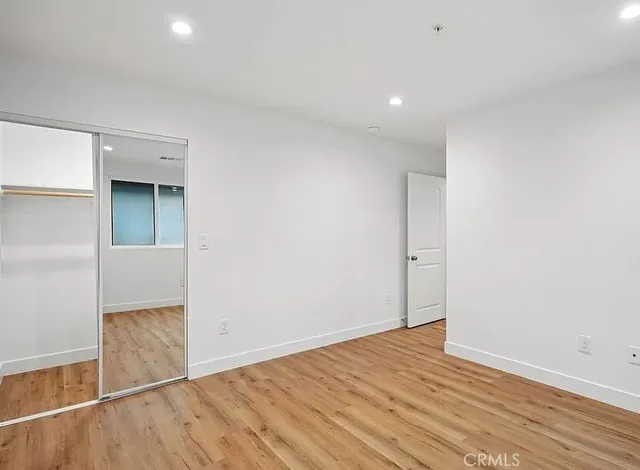 an empty room with wooden floor