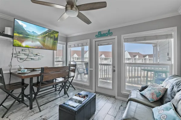 a living room with furniture and a floor to ceiling window