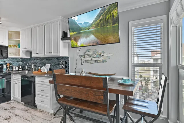 a kitchen with a table chairs and cabinets