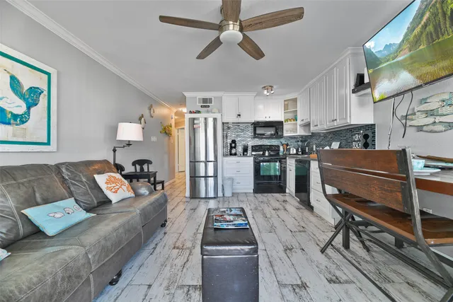 a living room with furniture and kitchen view