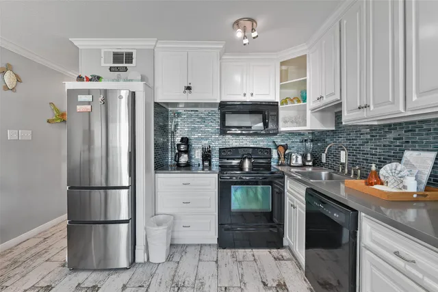 a kitchen with stainless steel appliances granite countertop a refrigerator stove and sink