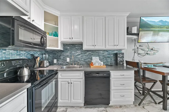 a kitchen with stainless steel appliances granite countertop a sink stove and cabinets