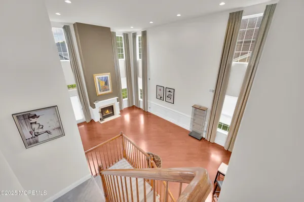 a view of a hallway with furniture and wooden floor