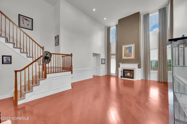 a view of a livingroom with wooden floor and a fireplace
