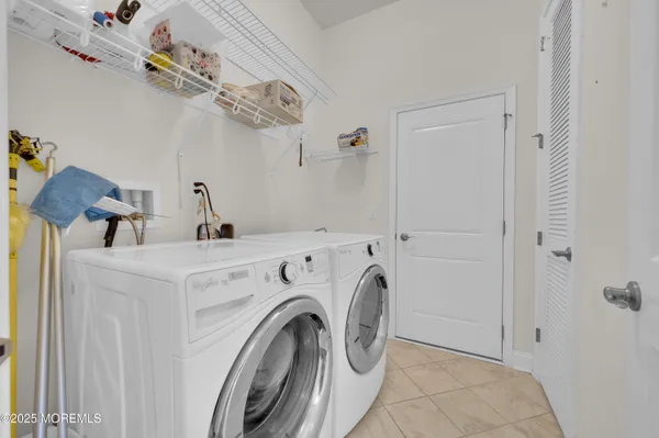 a view of storage and utility room with washer and dryer