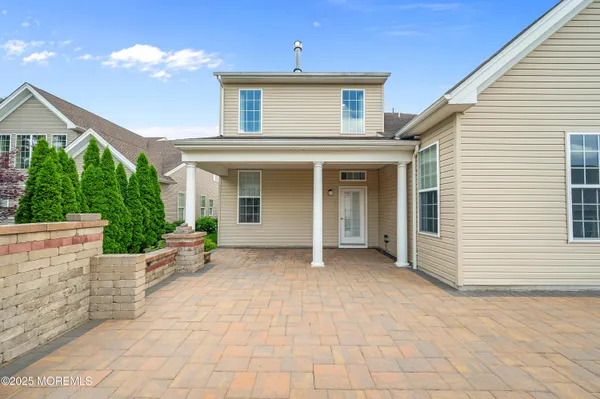 a view of a house with backyard and sitting area