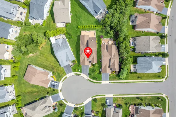 an aerial view of a house with garden space and street view