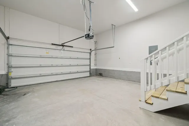 an empty room with wooden floor and ceiling fan