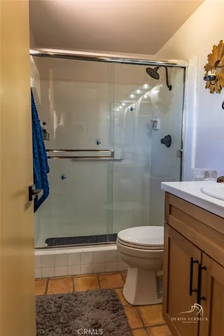 a bathroom with a shower a toilet and a sink