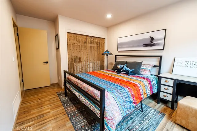 a bedroom with a bed and wooden floor