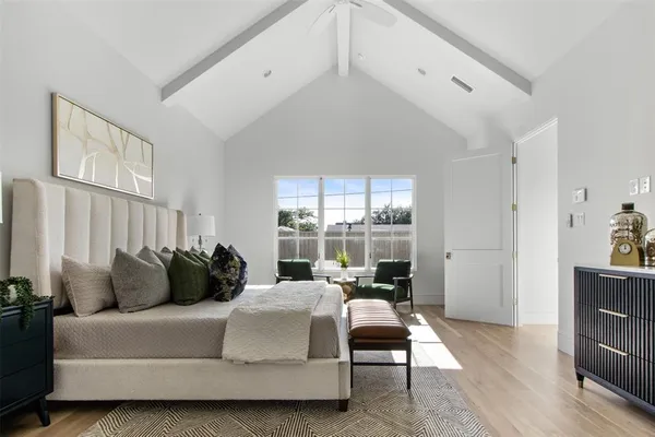 a bedroom with a bed and large window