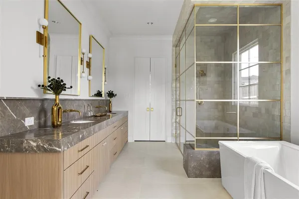 a bathroom with a granite countertop sink a bathtub and with shower