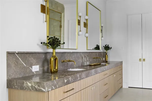a kitchen with a sink and a mirror