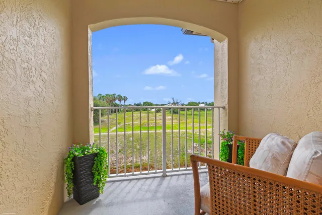 a view of a balcony with lake view and a potted plant