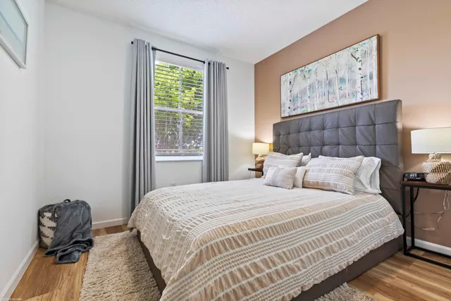 a bedroom with a bed and a painting on the wall