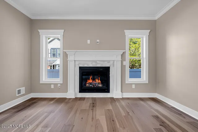 an empty room with a fireplace and window
