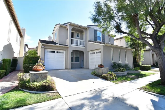a front view of a house with a yard garage and outdoor seating