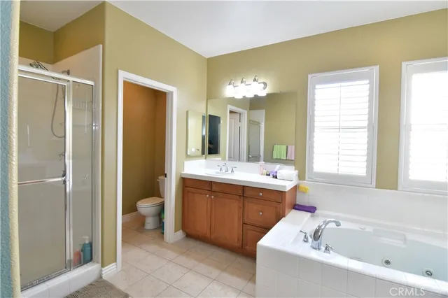 a bathroom with a bathtub sink and mirror
