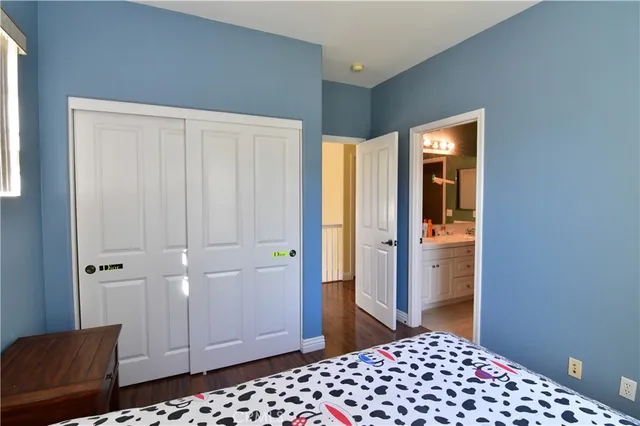 a bedroom with a dresser and a lamp