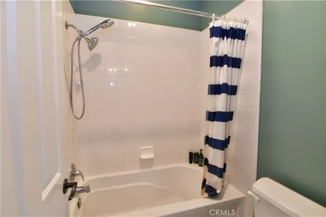 a bathroom with a shower a toilet and a shower