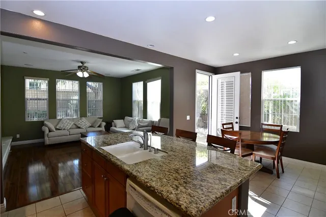 a living room with granite countertop kitchen island furniture and a potted plant