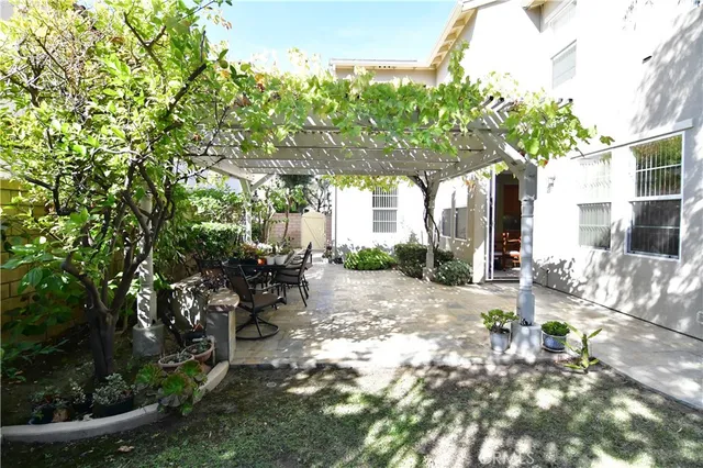 a view of a patio with table and chairs and potted plants