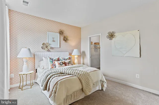 a bedroom with a bed and a lamp