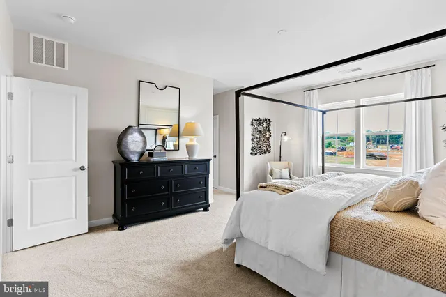 a bedroom with a bed and a dresser