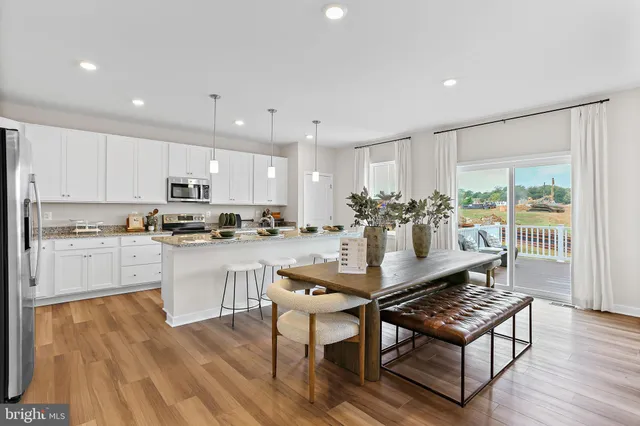 a kitchen with a table and chairs