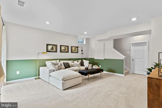 a living room with furniture and a potted plant