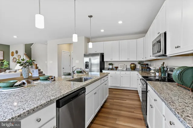 a kitchen with sink stove and cabinets