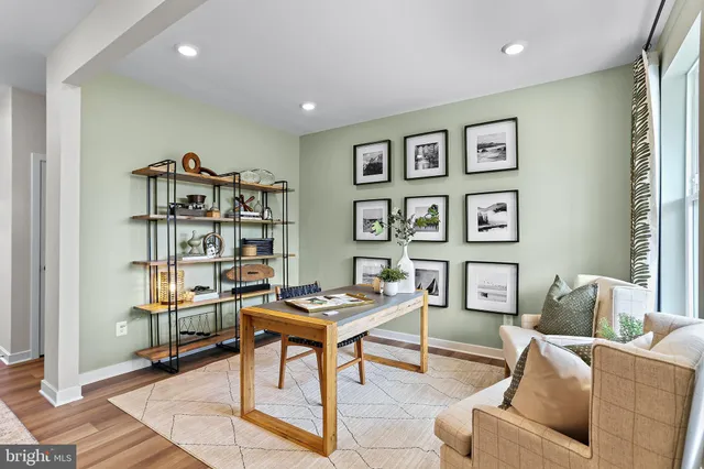 a living room with furniture a rug and a bookshelf