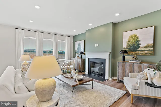 a living room with furniture fireplace and window